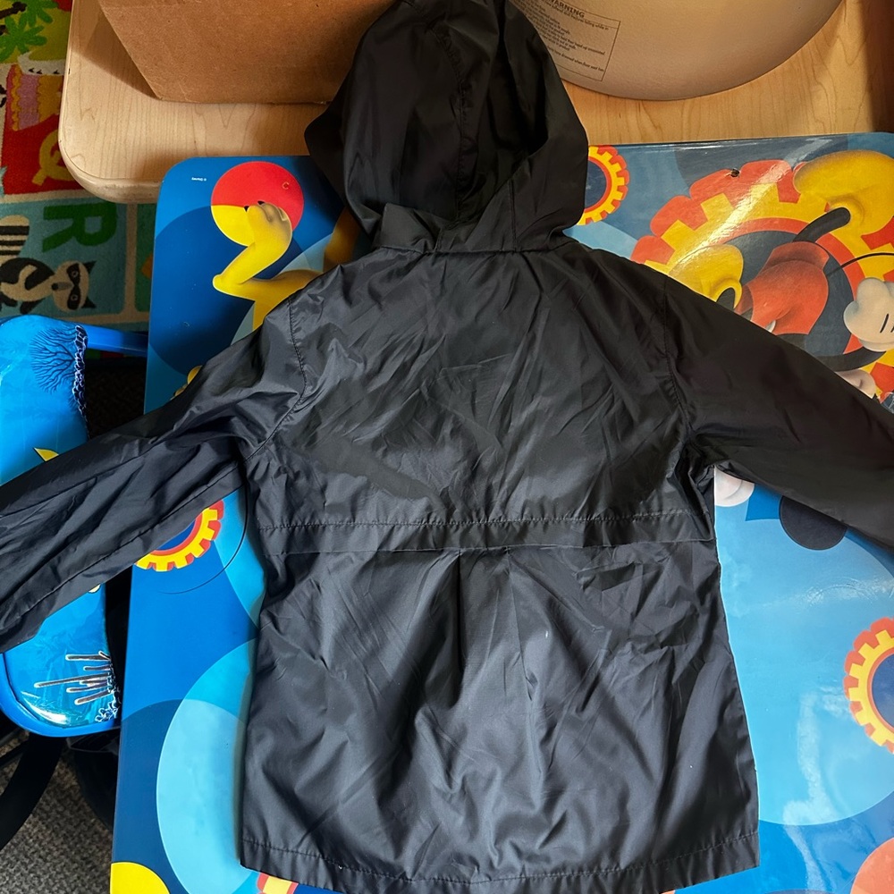 A Columbia rain jacket/wind breaker. It is black w/ a hood. No stains or tears.